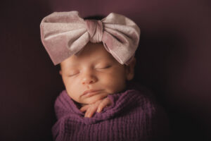 baby with big purple bow similar to what can be found at Baby Bliss in Dallas